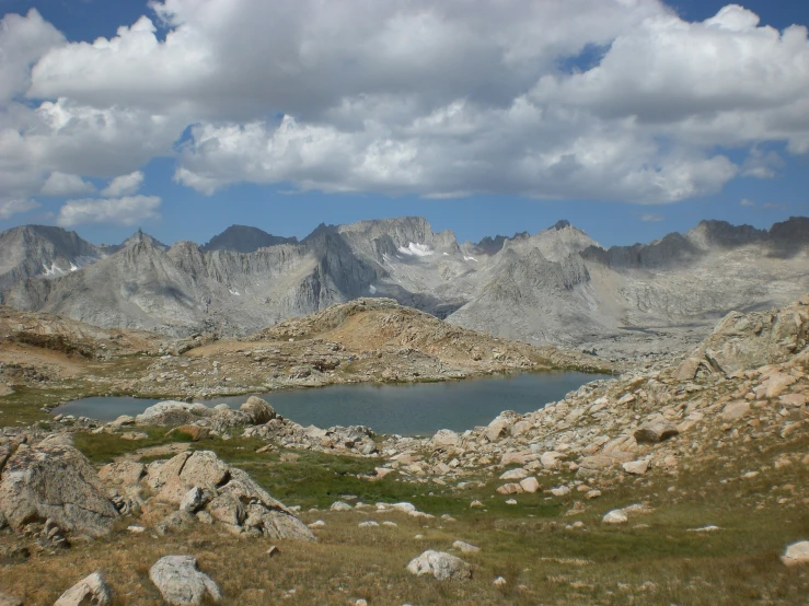 the rocky mountains with clouds in the sky