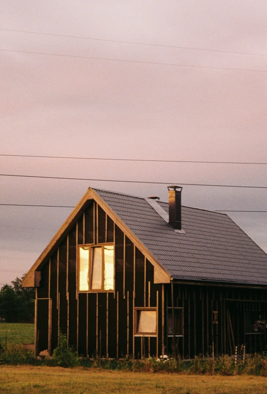 a house with the roof that has been made of wood with tined metal on it