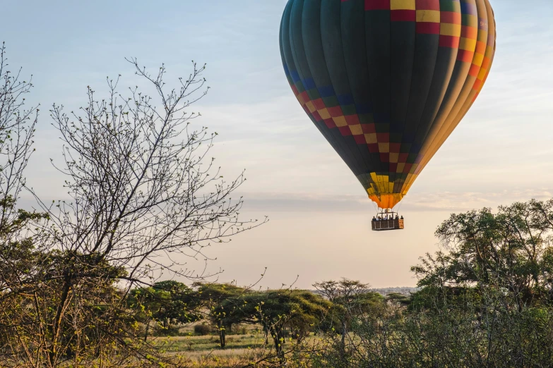 an inflatable  air balloon flying over trees