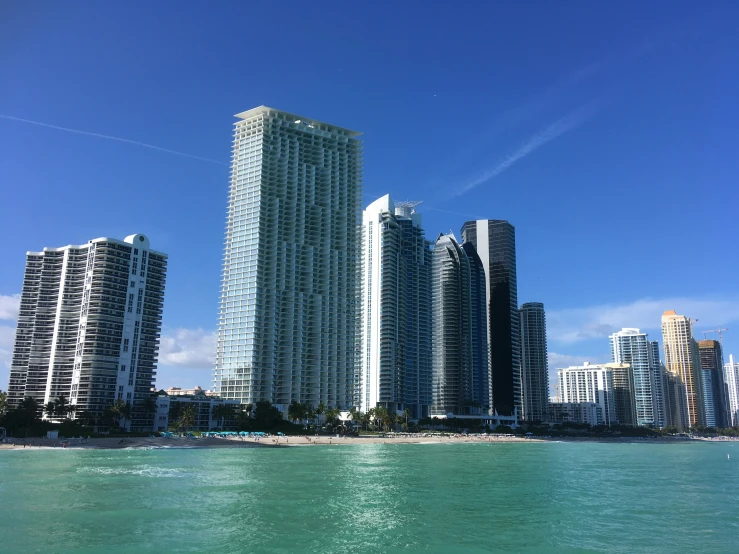 a view from the ocean of some skyscrs