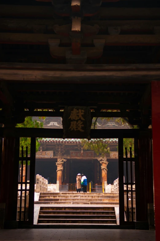 man with umbrella in chinese building entrance area