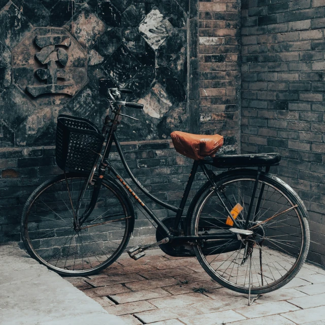 a bicycle parked in front of a brick building
