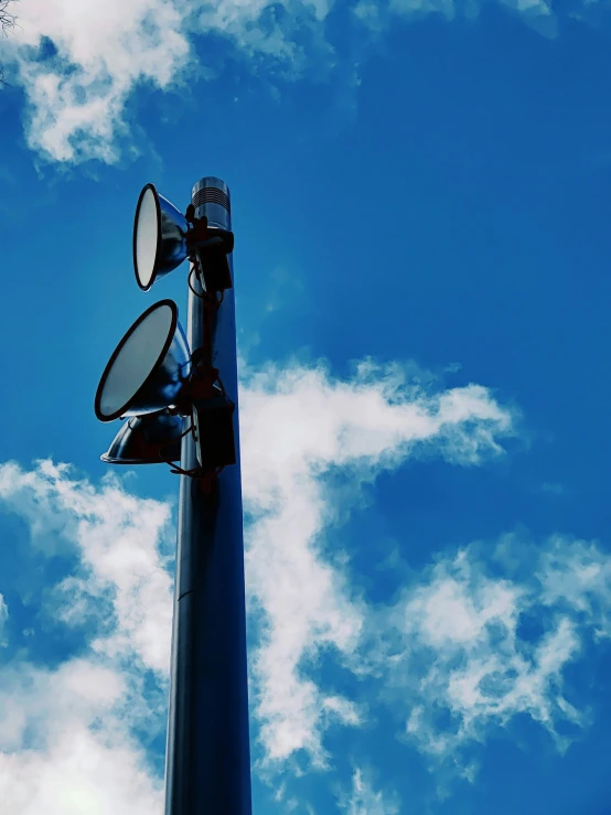 a street light sitting under a bright blue sky