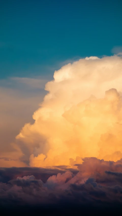 a jet in the sky with clouds above