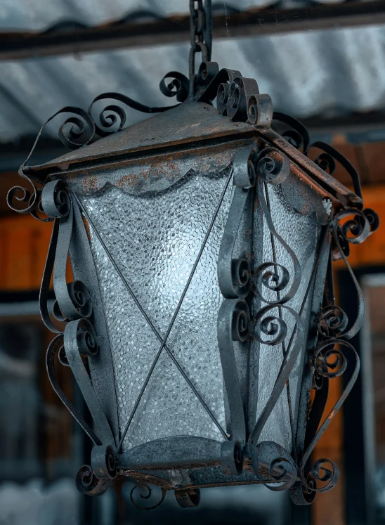 a close up of a street lamp hanging from a chain