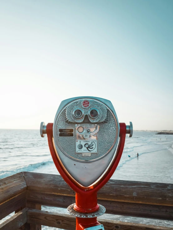 a coin operated binoculars that can see the beach