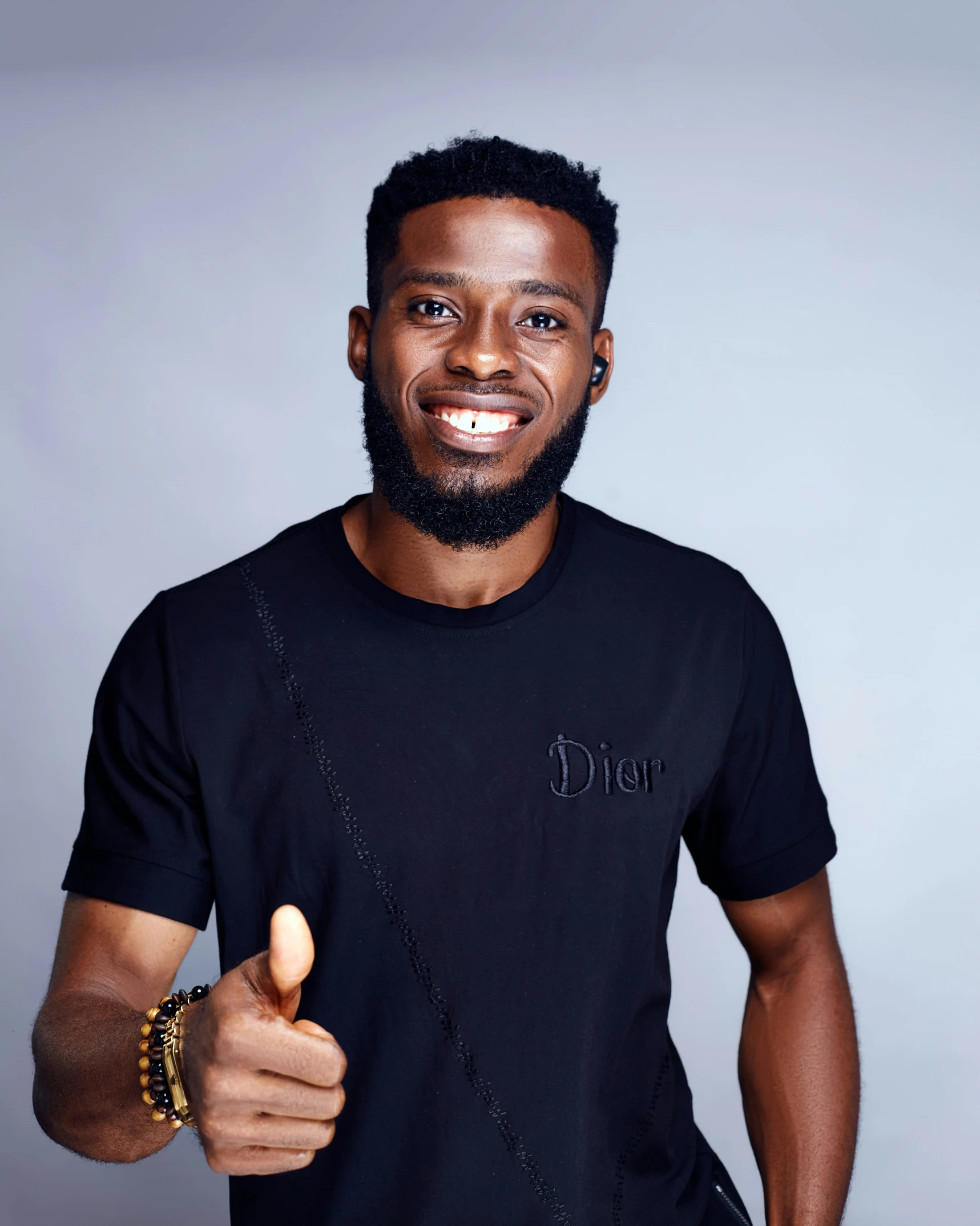 a man posing for a picture with a beard and a smiley face