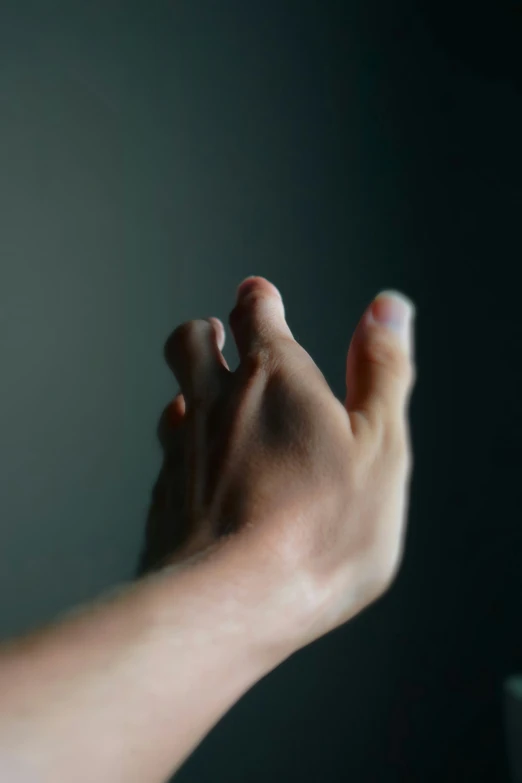 a person holding their foot up next to a wall