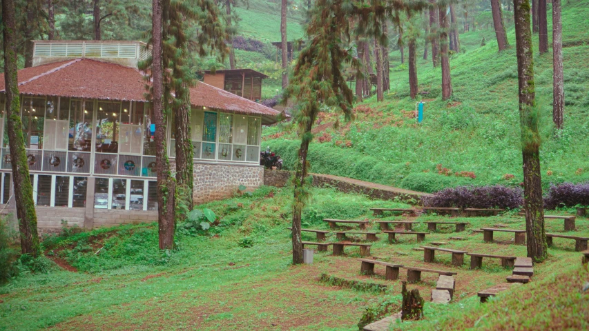 a building with many benches and trees on the side