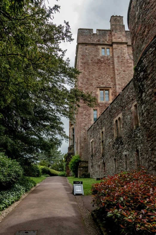 a big old castle has a road leading through it