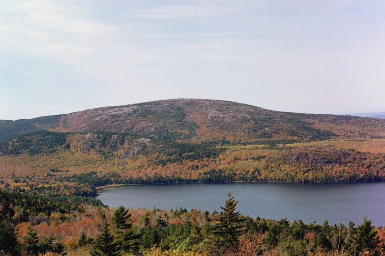 a body of water surrounded by trees on top of a mountain