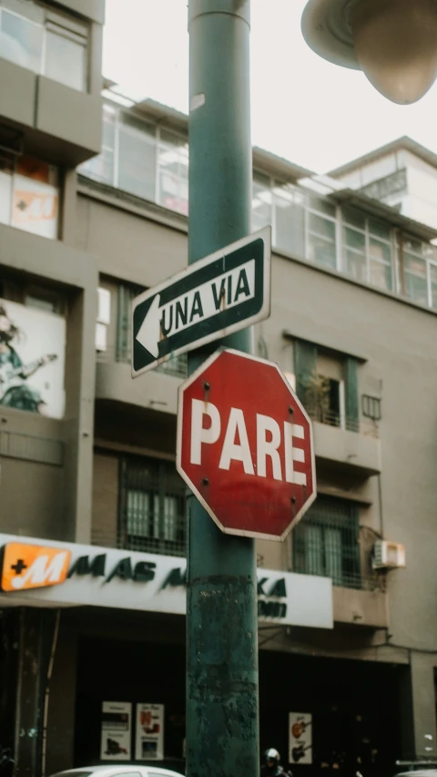 a red stop sign sitting on the corner of a street