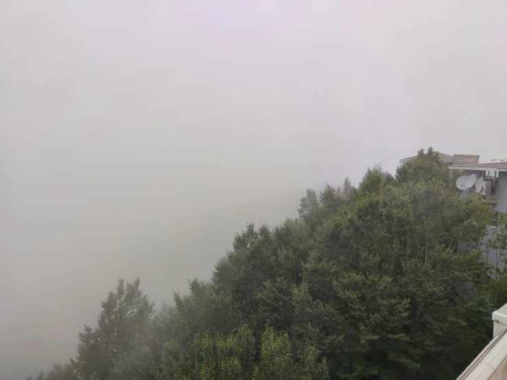 a foggy view of a building from a very high viewpoint