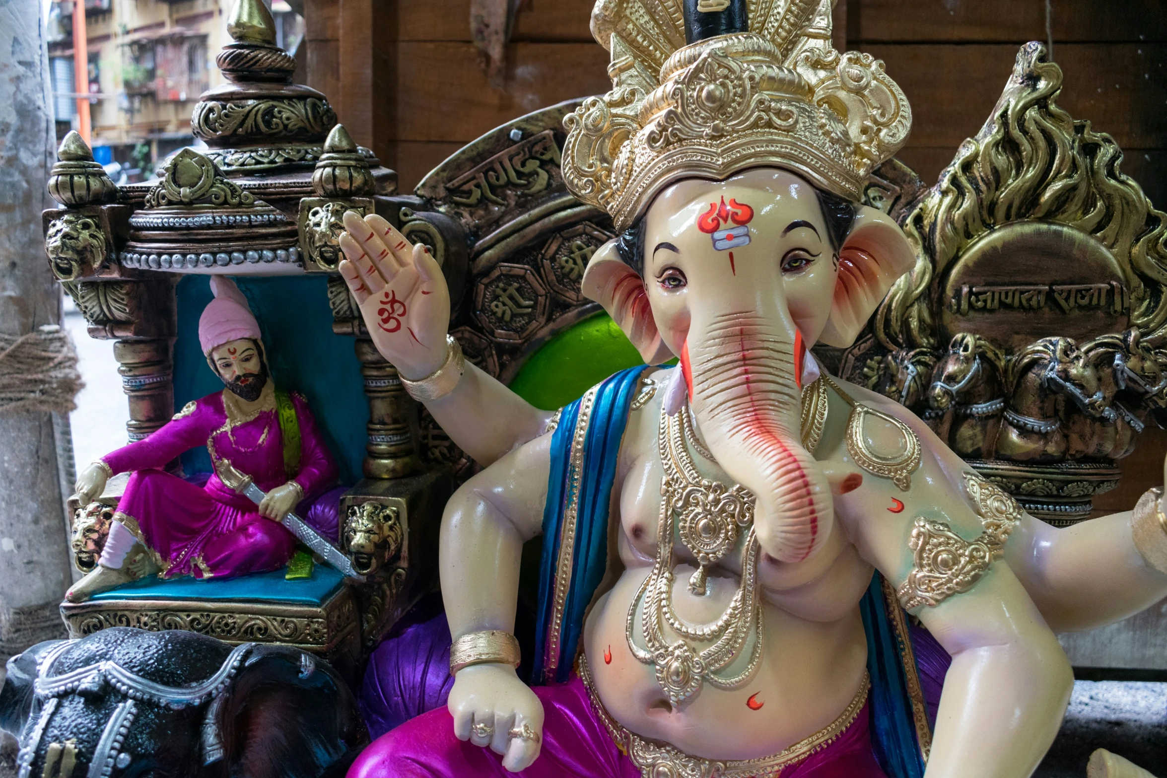 a statue of an elephant in front of a temple