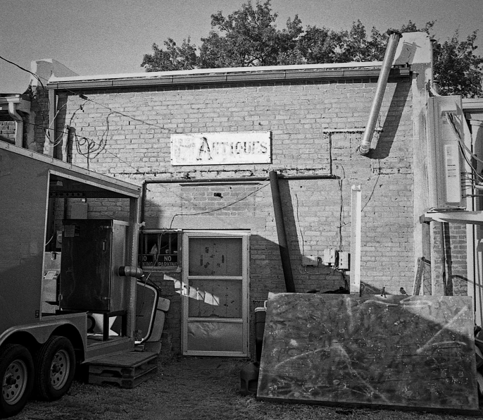 black and white pograph of storage unit next to building