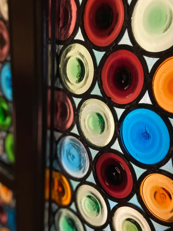 colorful circles of paint sitting on top of a glass