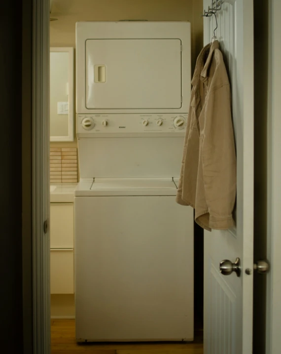 an empty laundry room with a drying machine and dryer