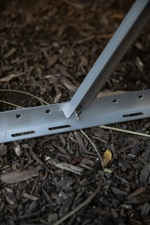 a close up of a metal fence laying on the ground