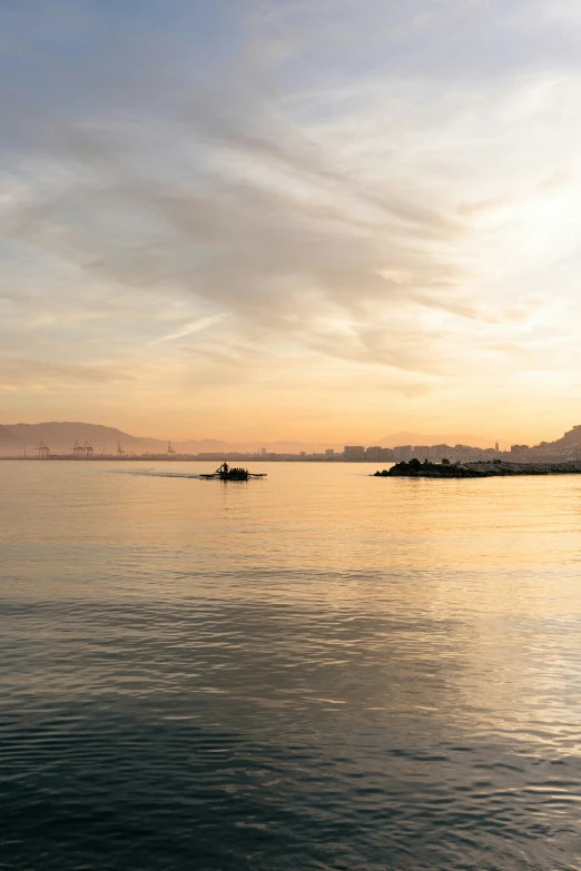 a lone boat floats in the open water