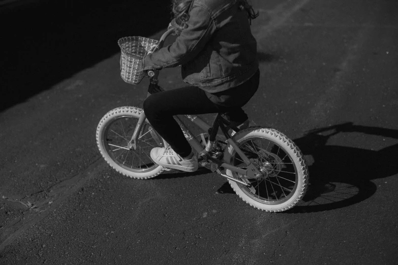 black and white pograph of a person riding a bicycle