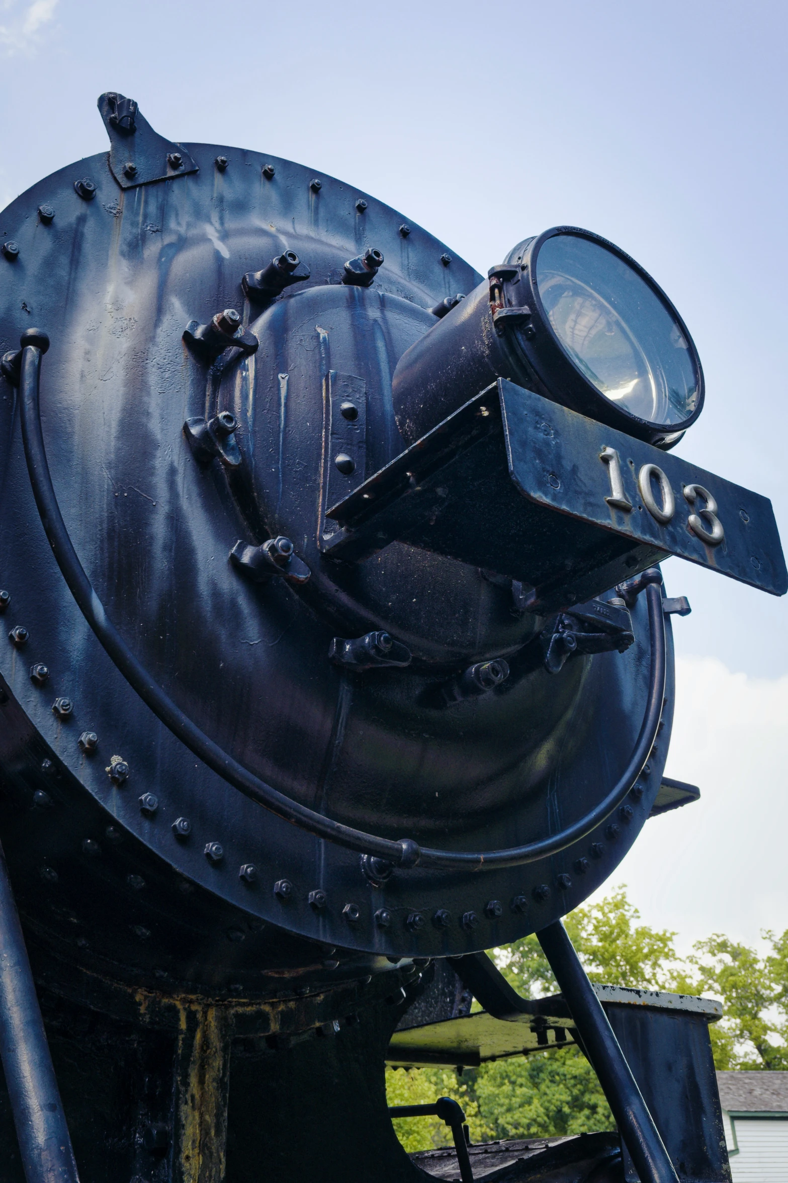 a close up po of the front of an old steam engine