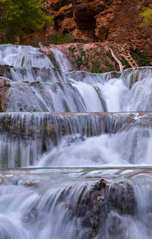 a man riding a surfboard on top of a waterfall