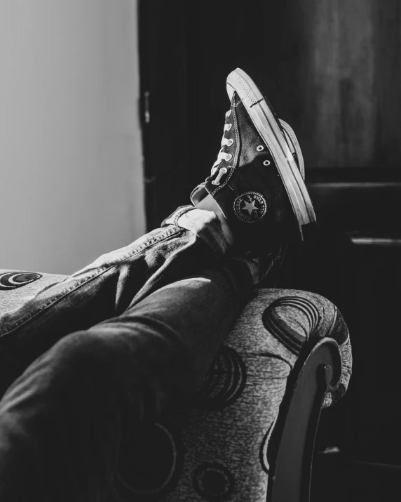 a person sitting on a couch with a shoe