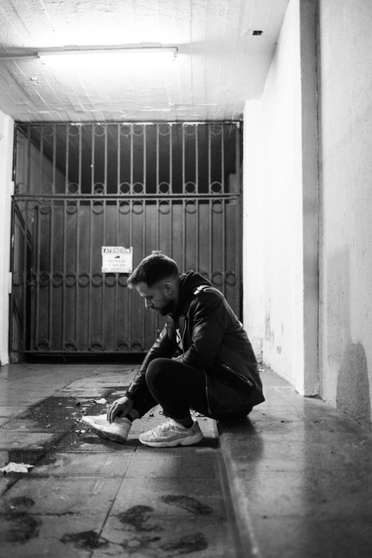 a man is sitting on the floor in an empty building