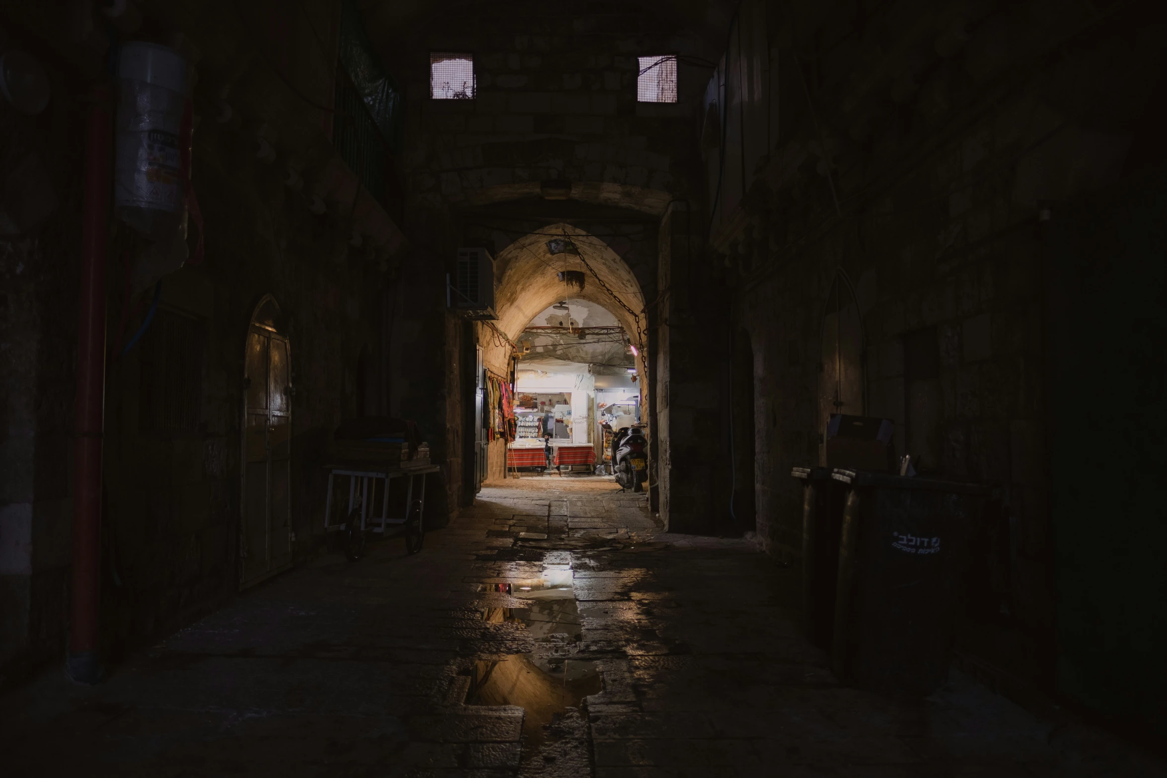 people are walking through a tunnel with some rain