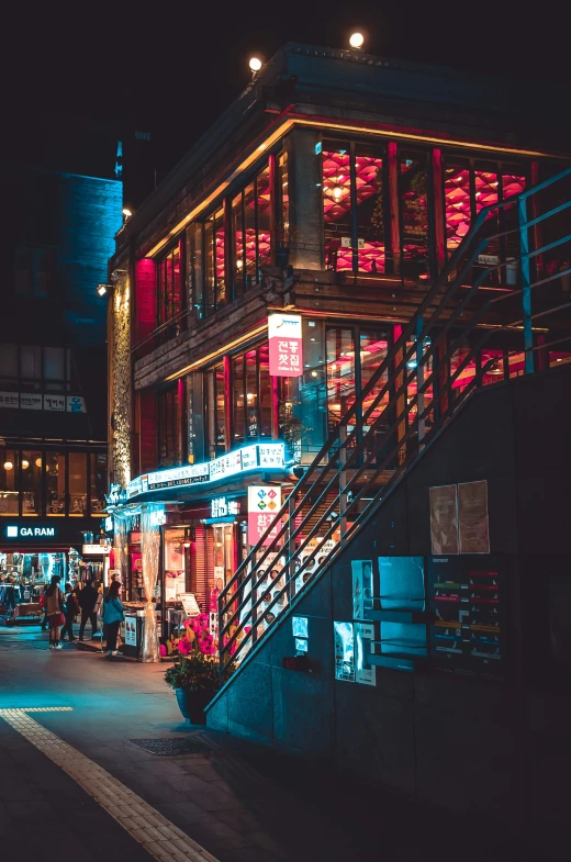 a building on the corner in front of some buildings