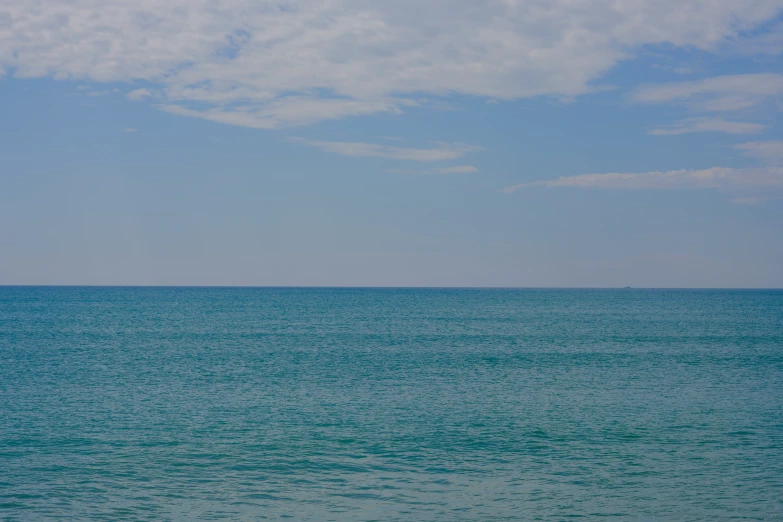 a boat on a calm ocean in the distance