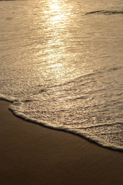 an image of the sun setting on the beach