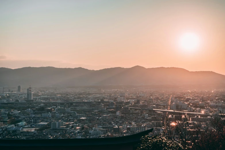 a view of the city in the background from the top of a hill