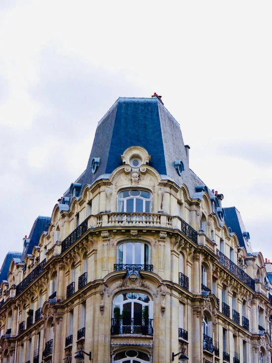 a building with large windows in front of a sky background