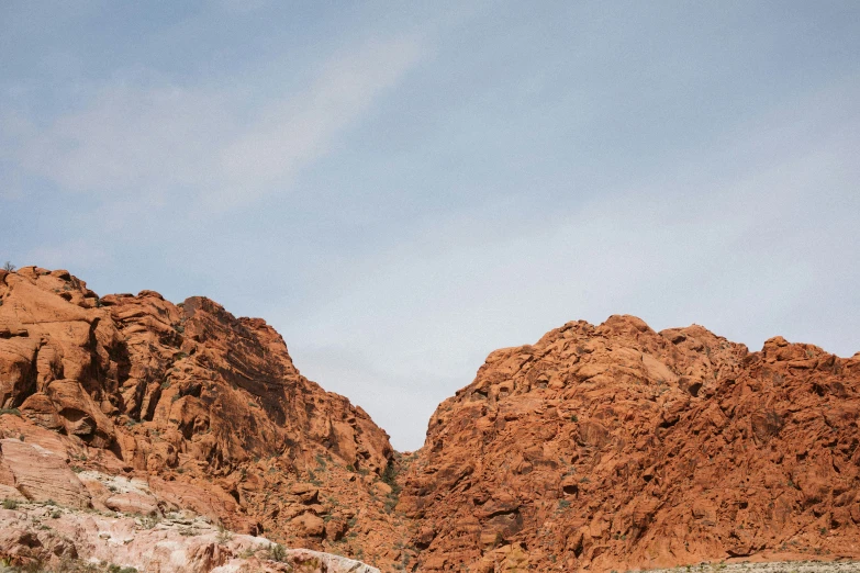 a group of rocks in the desert under a blue sky