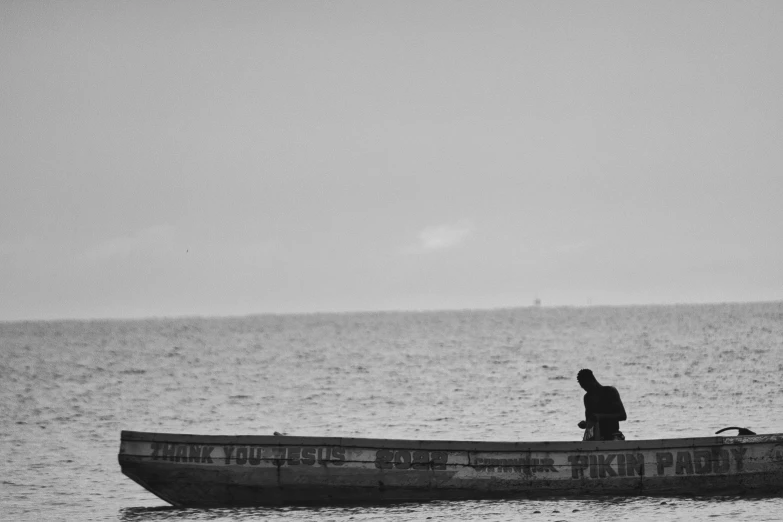 a man riding on the back of a boat next to a man