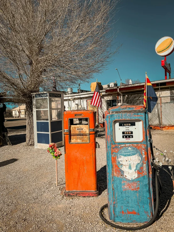 an old, run down gas station sits on the road