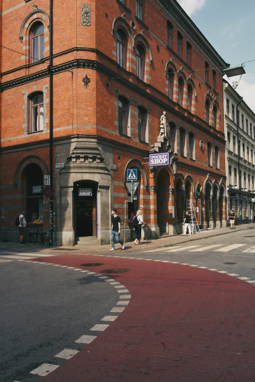 a red brick building with a small white arrow on the corner