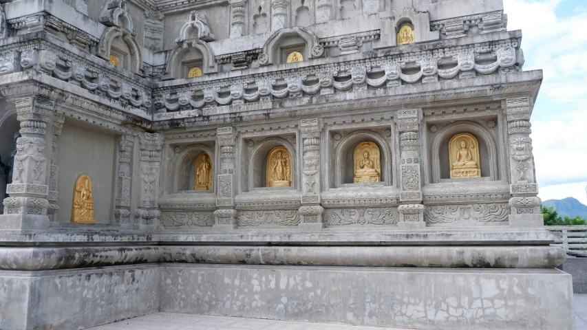 a big stone structure with two gold statues