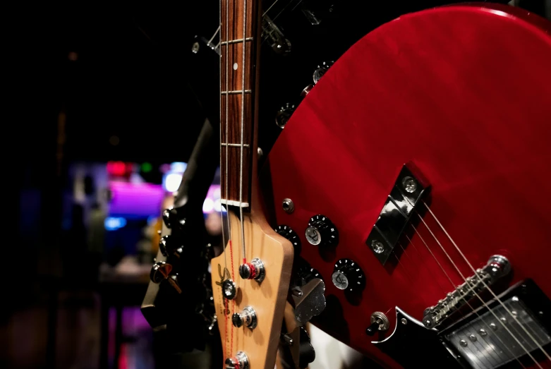 a red guitar with an extra bass attached to it