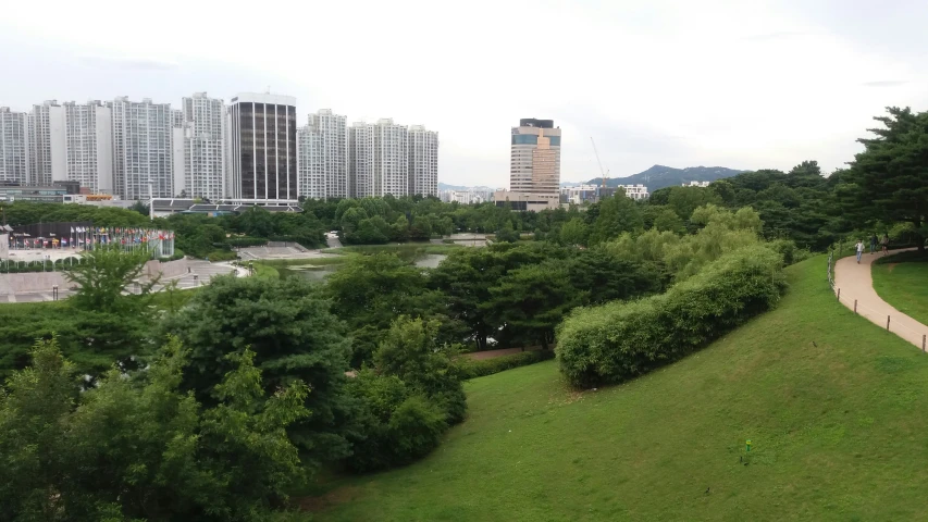 an empty park with some benches next to it and a view of a city