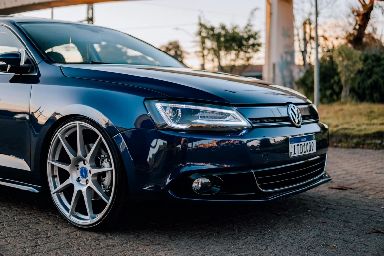 a blue vw with chrome rims and wheels