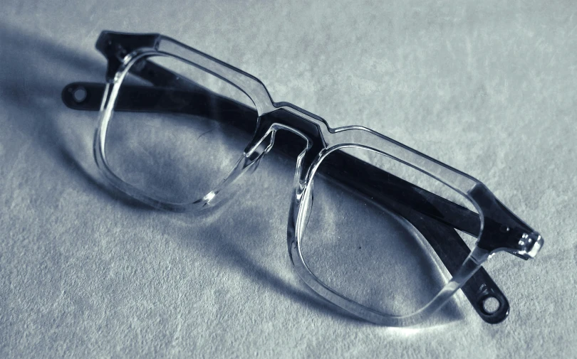 a pair of glasses on top of a white sheet
