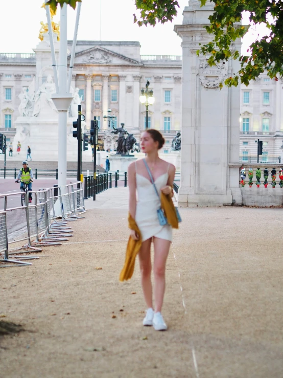 a woman walking on the street in front of buildings