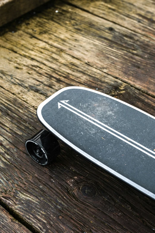 a skateboard that is laying on a wooden floor