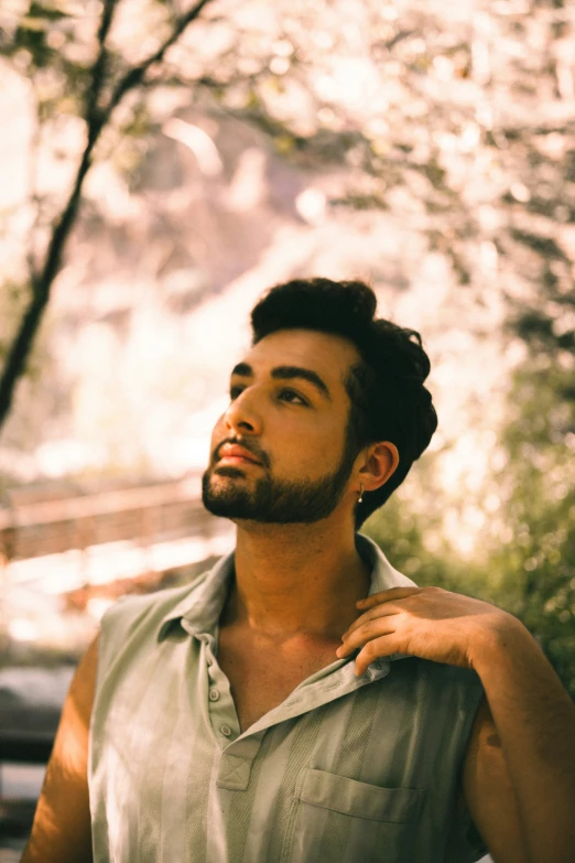 a young man stands staring into the sky