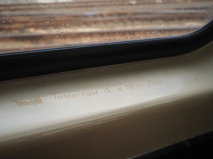 a dirty window on a moving train, that reads tonight is 9pm on