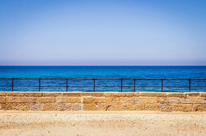 people riding bikes along the beach near water