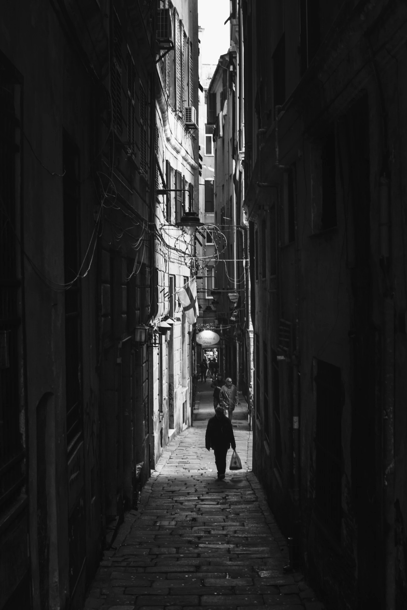 a dark alley leading to an old street