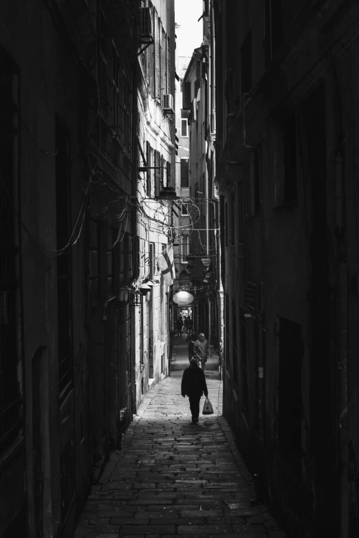 a dark alley leading to an old street